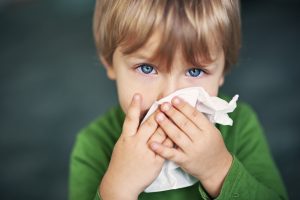 boy having allergy symptoms in children