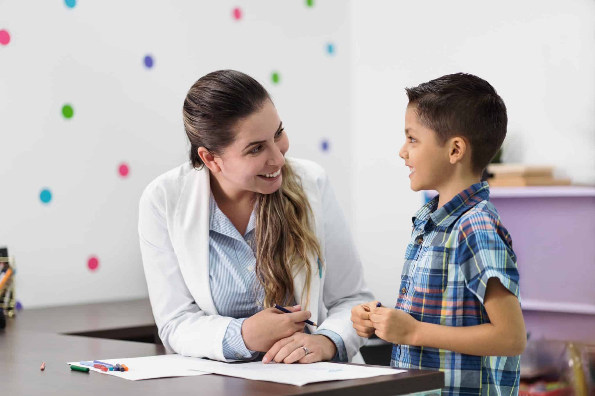 pediatric nurse assisting a child with behavioral concerns