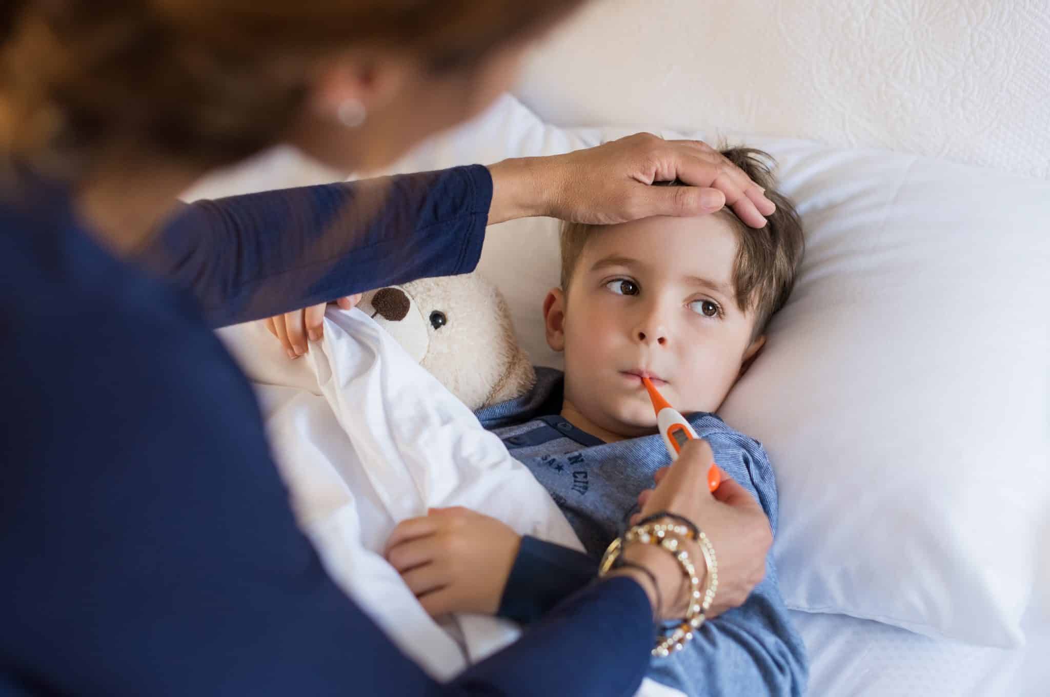 Child with Covid child sick in bed with covid
