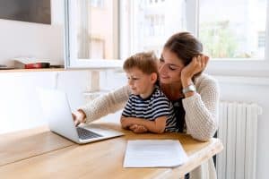 mother reading parent newsletter