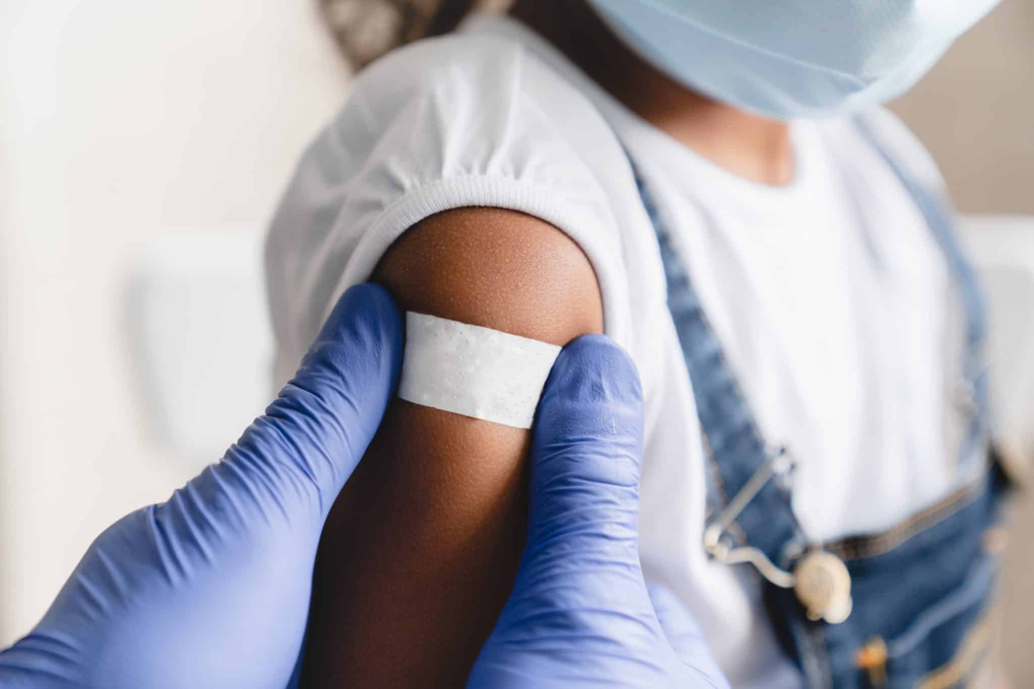 child receiving a pediatric covid shot in parker, colorado