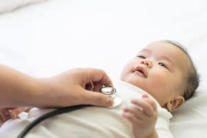 baby laying down during a newborn pediatric visit